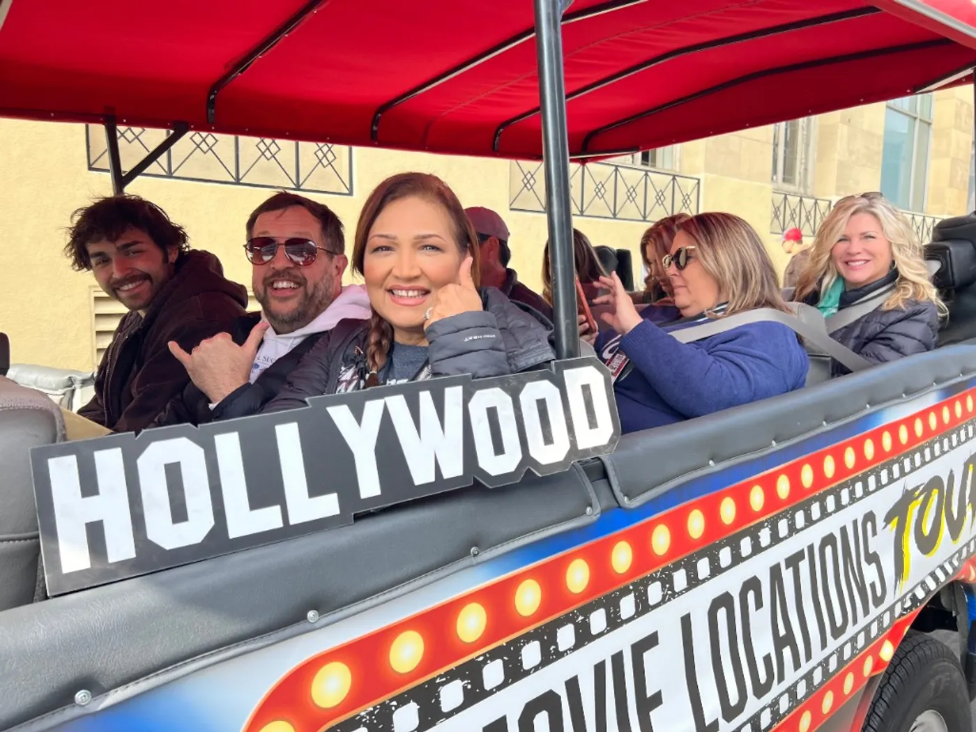 Happy Film Freak Tours guests riding through Hollywood on the custom tour vehicle